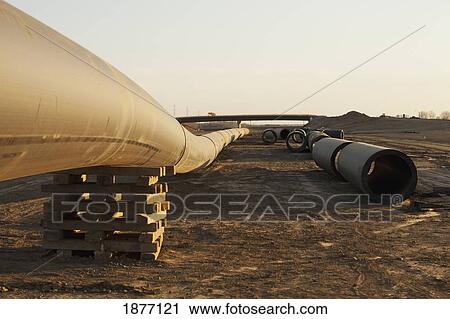 Stock Image - edmonton, alberta, canada; pipes laying on the ground in a construction site. Fotosearch