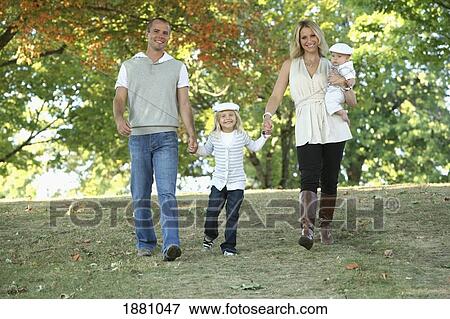 Stock Photo - family walking in a park together; gresham, oregon, united states of america. Fotosearch
