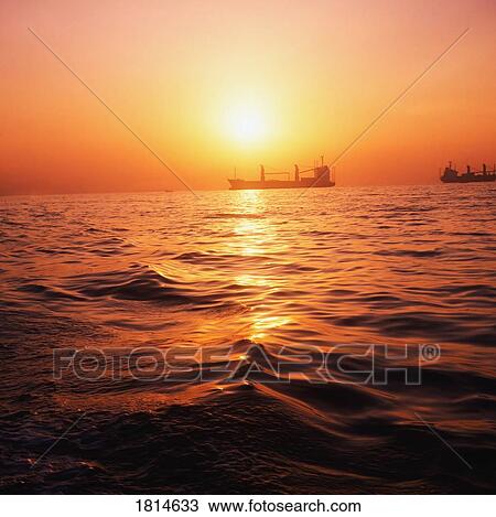 Freighters On The Ocean At Sunset View Large Photo Image Stock Image - Freighters On The Ocean At Sunset. Fotosearch