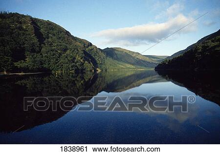 Stock Image - Glendalough, Co Wicklow, Ireland; Landscape And Clouds Reflecting In Water. Fotosearch