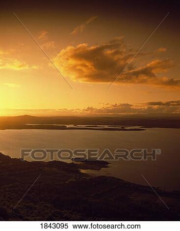 Stock Photography - High Angle View Of Landscape And Lake At Sunset. Fotosearch