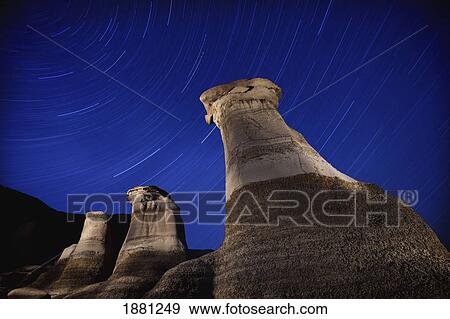 hoodoos and star trails in the sky; drumheller, alberta, canada View Large Photo Image Stock Photo - hoodoos and star trails in the sky; drumheller, alberta, canada. Fotosearch