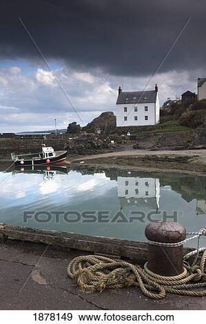 houses along the water and a boat on the shore; st. abb's head, scottish borders, scotland View Large Photo Image Stock Photo - houses along the water and a boat on the shore; st. abb's head, scottish borders, scotland. Fotosearch
