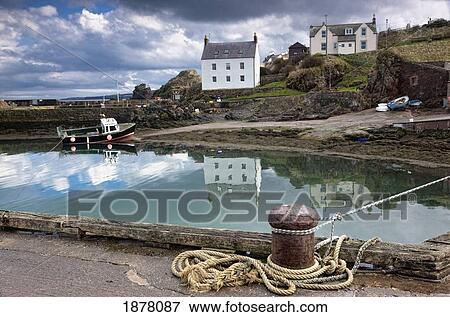 Stock Photo - houses and boats along the water; st. abb's head, scottish borders, scotland. Fotosearch