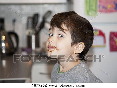 Stock Image - langley, british columbia, canada; a boy with chocolate around his mouth. Fotosearch
