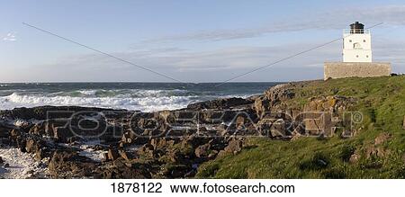 Stock Image - lighthouse on the coast; bamburgh, northumberland, england. Fotosearch