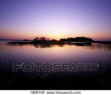 Lough Derg, Co Tipperary, Ireland; Sunset Over Small Island In Lake View Large Photo Image Stock Photo - Lough Derg, Co Tipperary, Ireland; Sunset Over Small Island In Lake. Fotosearch