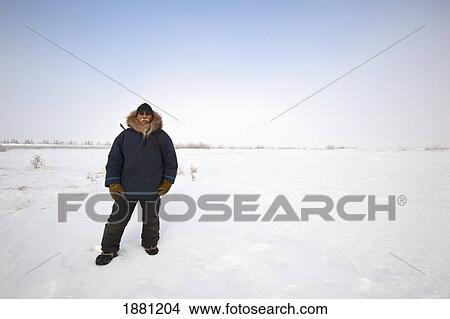 man standing in snow at wapusk national park; churchill, manitoba, canada View Large Photo Image Picture - man standing in snow at wapusk national park; churchill, manitoba, canada. Fotosearch