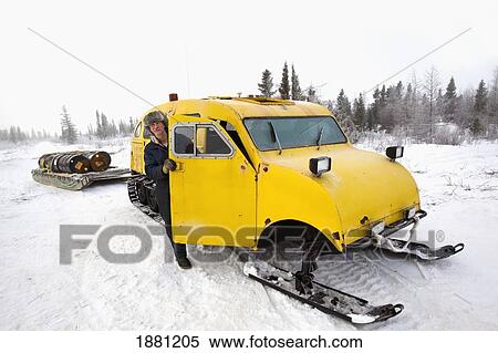 Stock Photography - man with snow sled in wapusk national park; churchill, manitoba, canada. Fotosearch