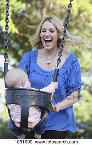 Stock Image - mother playing with young son in the swing; gresham, oregon, united states of america. Fotosearch