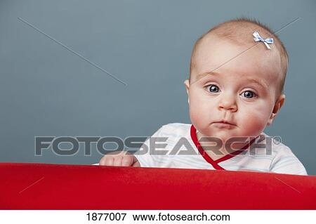 nashville, tennessee, united states of america; a baby girl sitting behind a red prop View Large Photo Image Stock Photo - nashville, tennessee, united states of america; a baby girl sitting behind a red prop. Fotosearch