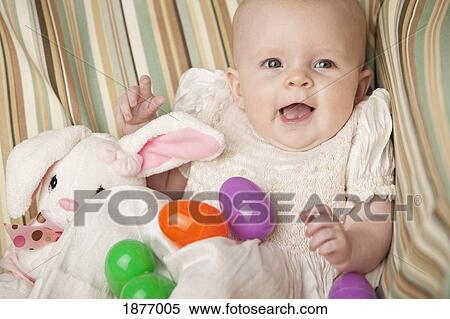 nashville, tennessee, united states of america; a baby girl with a stuffed toy easter bunny and plastic colorful easter eggs View Large Photo Image Stock Photography - nashville, tennessee, united states of america; a baby girl with a stuffed toy easter bunny and plastic colorful easter eggs. Fotosearch