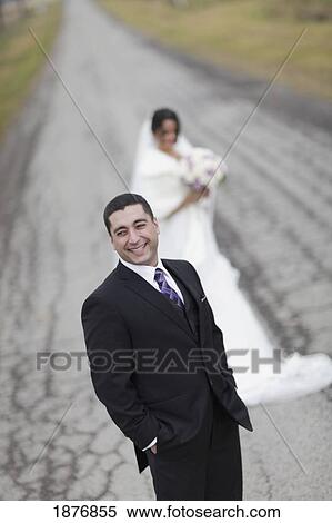 ontario, canada; a bride and groom standing on a road View Large Photo Image Stock Photography - ontario, canada; a bride and groom standing on a road. Fotosearch