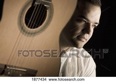 Picture - portrait of a man and a guitar; edmonton, alberta, canada. Fotosearch