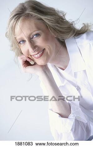 Stock Image - portrait of a woman wearing white and smiling. Fotosearch