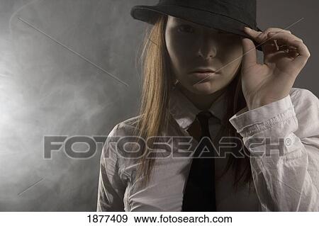 portrait of a young woman wearing a hat and necktie and smoke swirling around her View Large Photo Image Stock Photo - portrait of a young woman wearing a hat and necktie and smoke swirling around her. Fotosearch