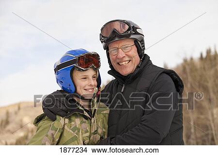 red deer, alberta, canada; a father and son wearing ski masks and helmets at a ski area View Large Photo Image Picture - red deer, alberta, canada; a father and son wearing ski masks and helmets at a ski area. Fotosearch