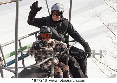 red deer, alberta, canada; a father and son on a chair lift at a ski area View Large Photo Image Stock Photograph - red deer, alberta, canada; a father and son on a chair lift at a ski area. Fotosearch