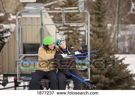 red deer, alberta, canada; a man and woman riding a chair lift at a ski area View Large Photo Image Stock Photo - red deer, alberta, canada; a man and woman riding a chair lift at a ski area. Fotosearch