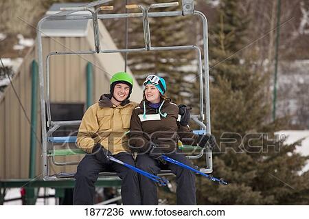 red deer, alberta, canada; a man and woman riding a chair lift at a ski area View Large Photo Image Stock Photograph - red deer, alberta, canada; a man and woman riding a chair lift at a ski area. Fotosearch