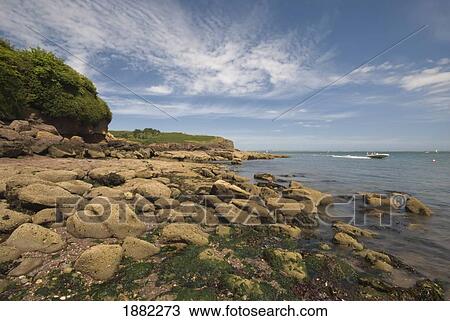 rocky seaside with motorboat traveling; dunmore east, ireland View Large Photo Image Stock Image - rocky seaside with motorboat traveling; dunmore east, ireland. Fotosearch