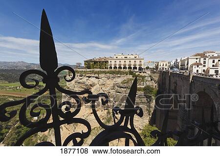 ronda, malaga, andalusia, spain; view across the tajo gorge to the national parador hotel and the new bridge (puente nuevo) View Large Photo Image Stock Photo - ronda, malaga, andalusia, spain; view across the tajo gorge to the national parador hotel and the new bridge (puente nuevo). Fotosearch