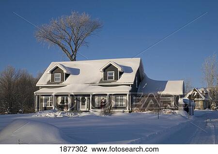 Stock Image - shefford, quebec, canada; a house covered in snow in winter. Fotosearch