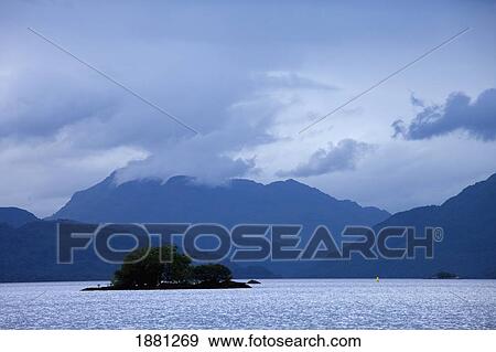Stock Photo - silhouette of the mountains surrounding loch lomand; scotland. Fotosearch
