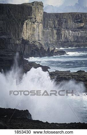 Stock Image - Steep Cliffs And Waves, Ireland. Fotosearch