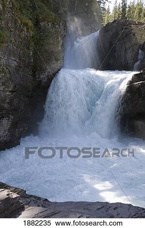 sunlight on waterfalls on the side of a mountain; montana, united states of america View Large Photo Image Stock Photography - sunlight on waterfalls on the side of a mountain; montana, united states of america. Fotosearch