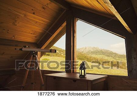 Stock Photograph - tarifa, cadiz, andalusia, spain; a loft with a telescope placed by the window. Fotosearch