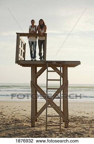 tarifa, cadiz, andalusia, spain; a mother and daughter standing up on a wooden tower on los lances beach along costa de la luz View Large Photo Image Stock Image - tarifa, cadiz, andalusia, spain; a mother and daughter standing up on a wooden tower on los lances beach along costa de la luz. Fotosearch
