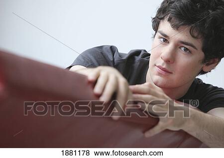 Stock Photo - teenage boy relaxing on the sofa. Fotosearch