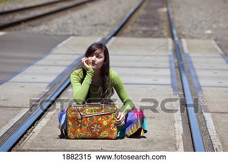 teenage girl sitting on the train tracks downtown; portland, oregon, united states of america View Large Photo Image Stock Photography - teenage girl sitting on the train tracks downtown; portland, oregon, united states of america. Fotosearch