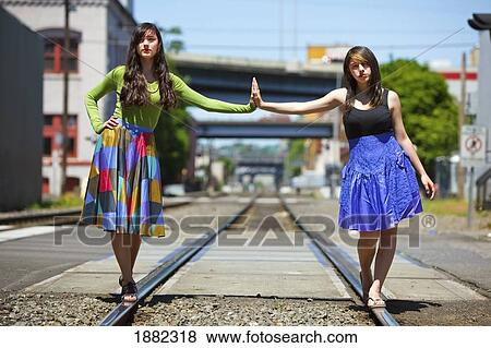 teenage girls balancing on the train tracks downtown; portland, oregon, united states of america View Large Photo Image Stock Photo - teenage girls balancing on the train tracks downtown; portland, oregon, united states of america. Fotosearch