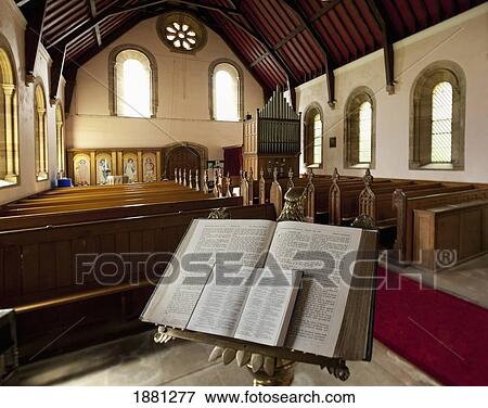 Stock Photo - the bible open on a stand at the back of howick church; northumberland, england. Fotosearch