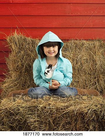 three hills, alberta, canada; a young girl holding a bunny rabbit View Large Photo Image Stock Image - three hills, alberta, canada; a young girl holding a bunny rabbit. Fotosearch