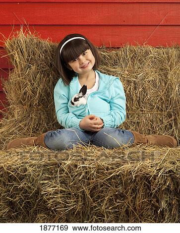 three hills, alberta, canada; a young girl holding a bunny rabbit View Large Photo Image Stock Photo - three hills, alberta, canada; a young girl holding a bunny rabbit. Fotosearch