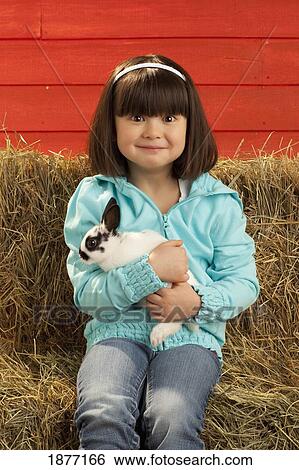 three hills, alberta, canada; a young girl holding a bunny rabbit View Large Photo Image Stock Photograph - three hills, alberta, canada; a young girl holding a bunny rabbit. Fotosearch