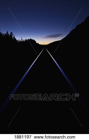 Stock Photo - train tracks at sunset; banff, alberta, canada. Fotosearch