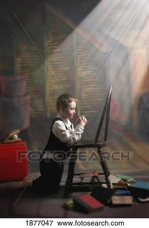 victoria, british columbia, canada; a young boy praying with a light beam on him View Large Photo Image Stock Photo - victoria, british columbia, canada; a young boy praying with a light beam on him. Fotosearch