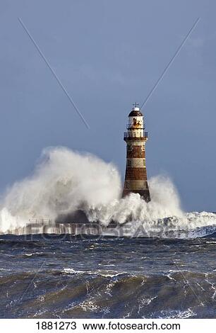 Stock Image - waves crashing against roker lighthouse; sunderland, tyne and wear, england. Fotosearch