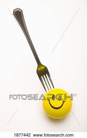 yellow happy face with a fork stuck in it's head; edmonton, alberta, canada View Large Photo Image Stock Image - yellow happy face with a fork stuck in it's head; edmonton, alberta, canada. Fotosearch