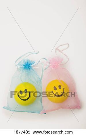 yellow happy faces in blue and pink bags; edmonton, alberta, canada View Large Photo Image Stock Photography - yellow happy faces in blue and pink bags; edmonton, alberta, canada. Fotosearch