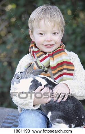 young boy holding his pet rabbit; portland, oregon, united states of america View Large Photo Image Stock Image - young boy holding his pet rabbit; portland, oregon, united states of america. Fotosearch