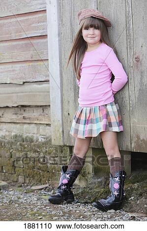 young girl wearing a hat and cowboy boots; troutdale, oregon, united states of america View Large Photo Image Stock Image - young girl wearing a hat and cowboy boots; troutdale, oregon, united states of america. Fotosearch