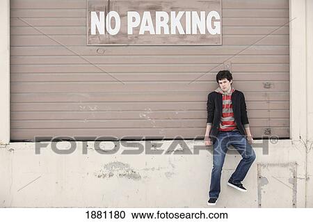young man sitting at a loading dock; portland, oregon, united states of america View Large Photo Image Stock Image - young man sitting at a loading dock; portland, oregon, united states of america. Fotosearch