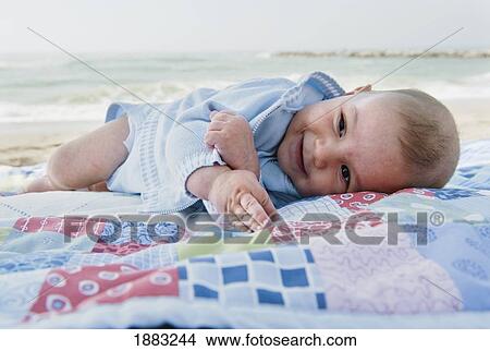 A Baby Boy Laying On A Blanket On The Beach; Benalmadena Costa, Costa Del Sol, Malaga, Andalusia, Spain View Large Photo Image Picture - A Baby Boy Laying On A Blanket On The Beach; Benalmadena Costa, Costa Del Sol, Malaga, Andalusia, Spain. Fotosearch