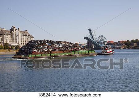 A Barge Full Of Crushed Vehicles Being Pulled In The Water; Langley, British Columbia, Canada View Large Photo Image Picture - A Barge Full Of Crushed Vehicles Being Pulled In The Water; Langley, British Columbia, Canada. Fotosearch