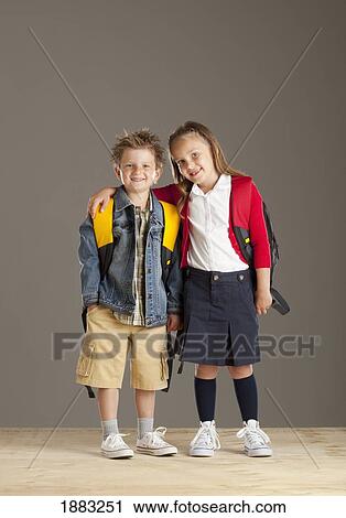 A Boy And Girl Carrying Backpacks View Large Photo Image Stock Image - A Boy And Girl Carrying Backpacks. Fotosearch